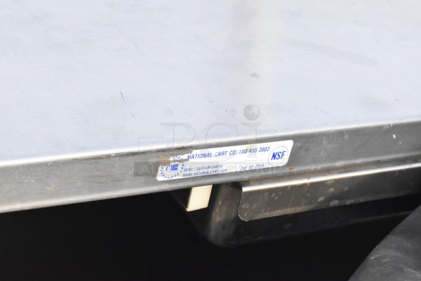 Metal cart with two shelves and under shelf on casters. Label indicates "National Cart Co.," NSF certified, dated Jan 12, 2018.