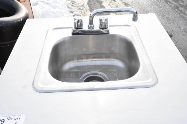 Portable sink on casters with instant flow water heater, stainless steel basin, dual faucet, in good condition.