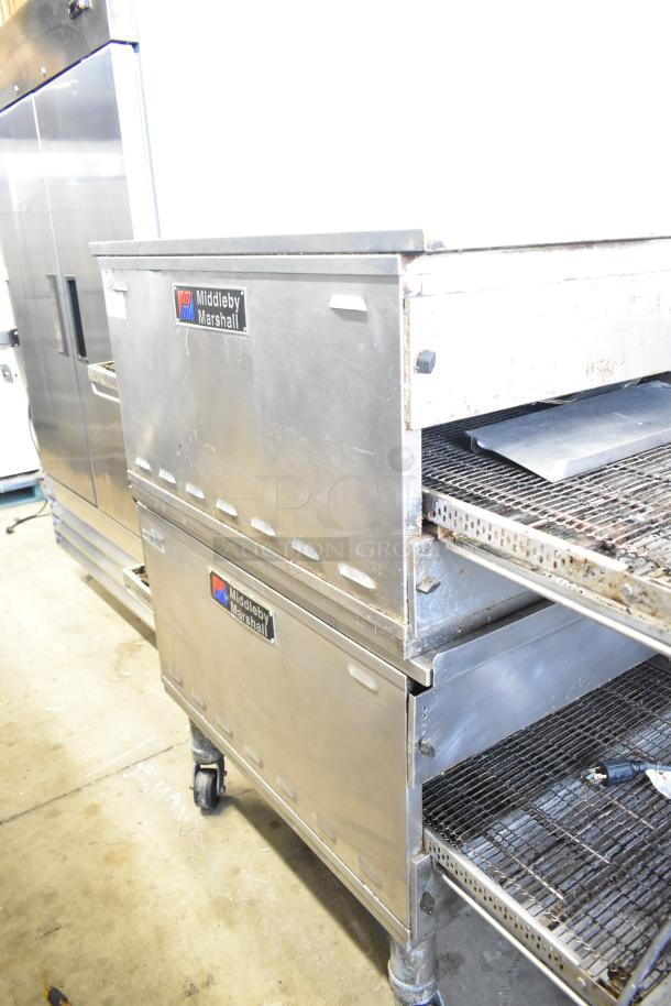 Two Middleby Marshall PS638G conveyor pizza ovens, natural gas, 89,000 BTU, on commercial casters, in used condition.