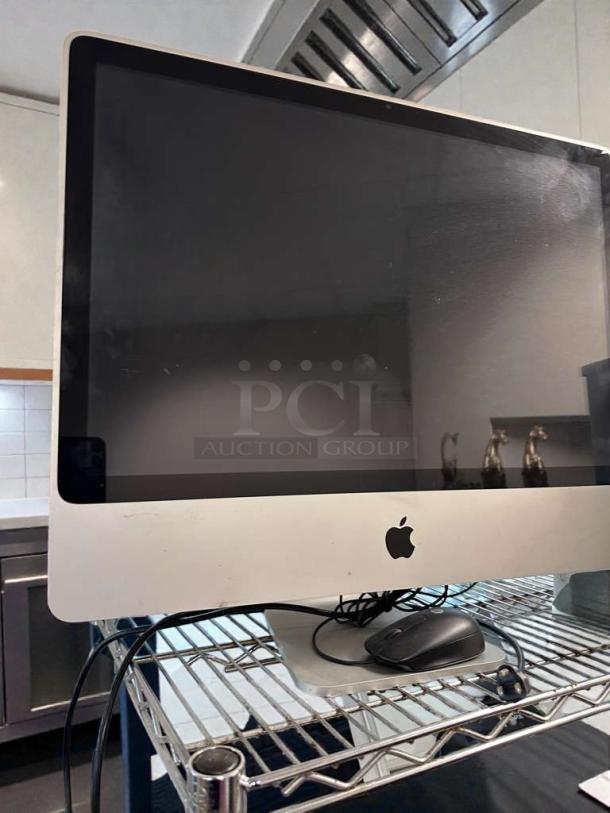 Apple iMac 21.5-Inch desktop in excellent condition, fully tested and operational. Visible Apple logo, includes wired mouse.