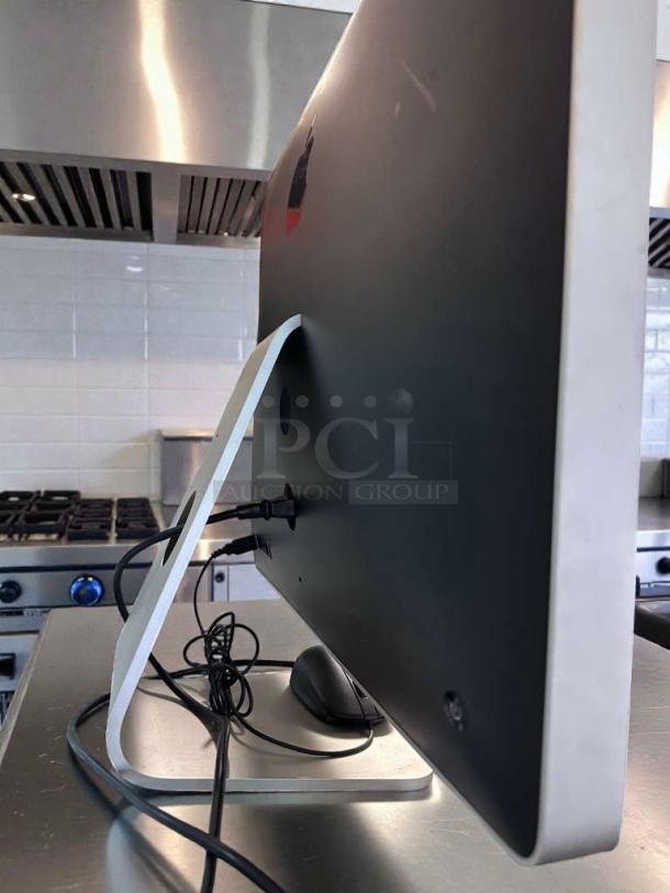 Apple iMac 21.5-Inch, excellent condition, rear view showing ports and stand, model APL-M-IMAC-0381, fully tested.