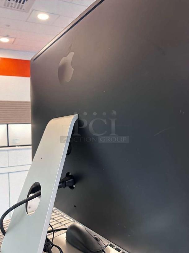 Apple iMac 21.5-Inch in excellent condition, showing rear view. Includes stand and cable, fully tested and operational.