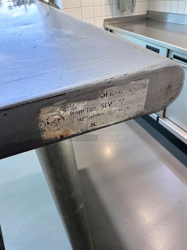 Commercial stainless steel work table, 48" x 24", with undershelf, NSF certified. Refined condition, fully tested.