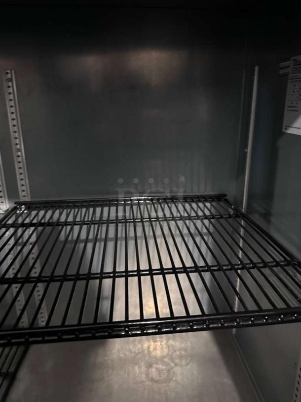 True TBB Series commercial back bar glass door refrigerator interior, excellent condition, black wire shelves, UL listed.