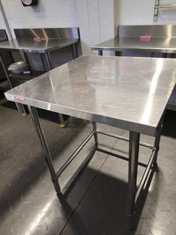 Commercial stainless steel work table, 48" x 30", heavy-duty, unbranded, top-tier condition, fully tested, operational.