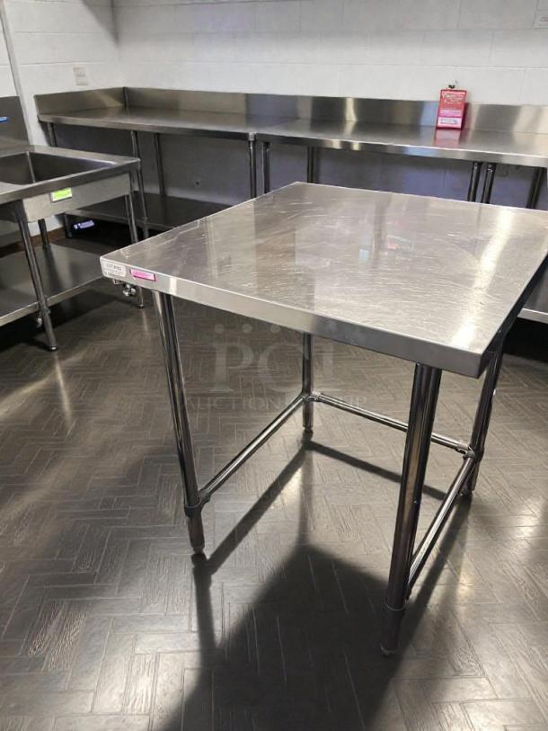 Commercial stainless steel work table, 48"x30", heavy-duty, top-tier condition, fully tested, unbranded.