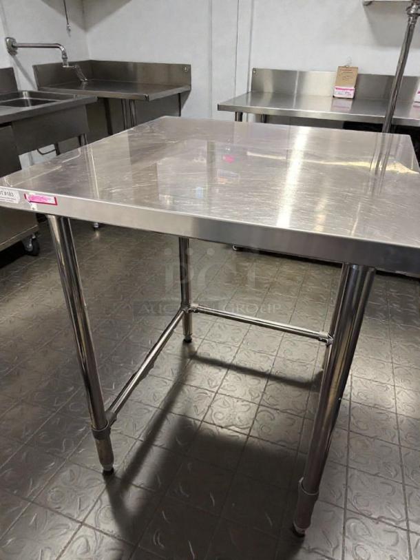Commercial stainless steel work table, 48" x 30", heavy-duty, top-tier condition, fully tested, unbranded.