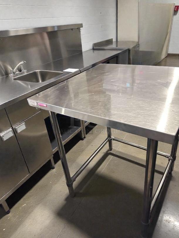 Commercial stainless steel work table, 48"x30", heavy-duty, top-tier condition, fully operational, unbranded.