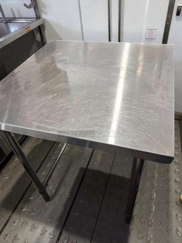 Commercial stainless steel work table, 48" x 30", heavy-duty, top-tier condition, unbranded, fully operational.