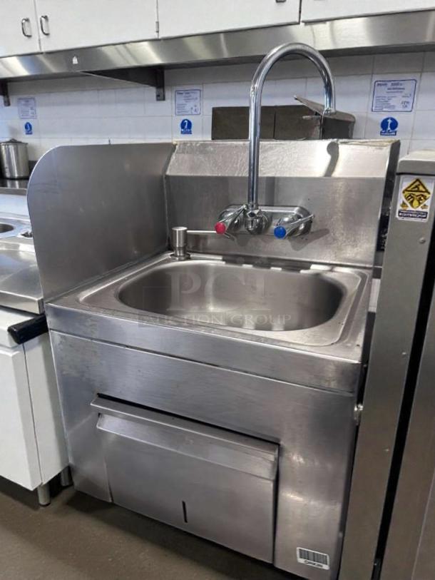 High-grade commercial stainless steel hand wash sink with gooseneck faucet and built-in paper towel dispenser, excellent condition.