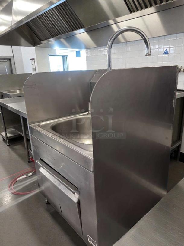 Commercial stainless steel hand wash sink with gooseneck faucet, built-in paper towel dispenser, high-grade condition, fully tested.