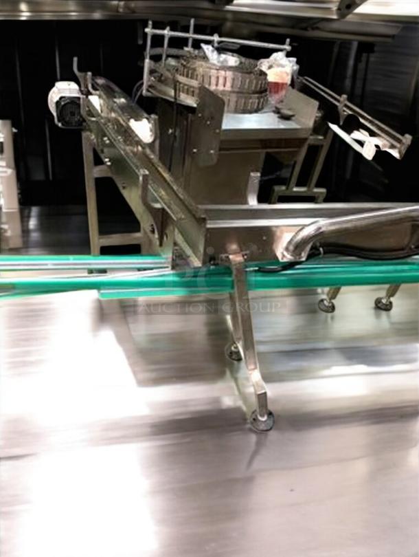 Stainless steel bottle conveyor system, adjustable speed, premium condition, fully tested, part of complete production line.