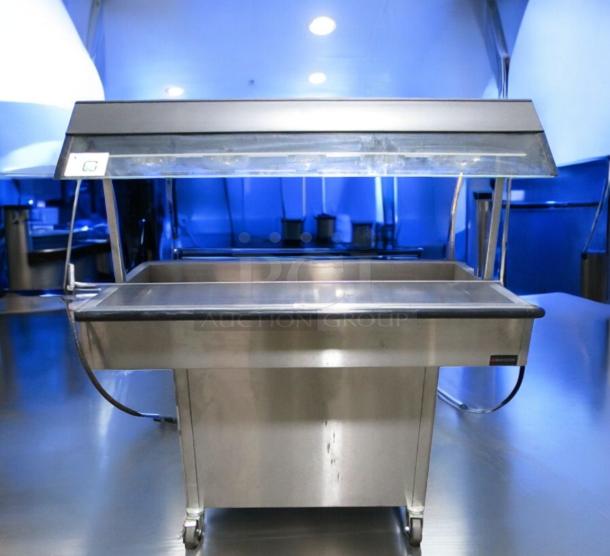 Very good condition Duke E304 4-well electric steam table with sneeze guard, 208V, fully tested, by Duke Manufacturing.