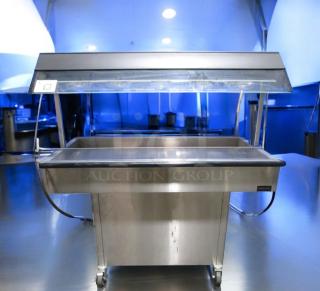 Very good condition Duke E304 4-well electric steam table with sneeze guard, 208V, fully tested, by Duke Manufacturing.
