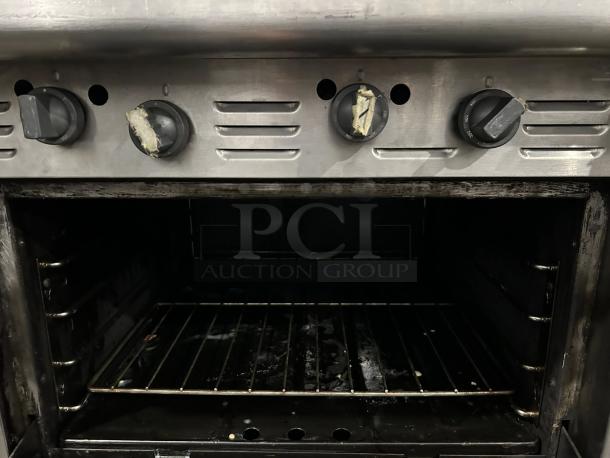 Garland G36-G36R gas range with griddle and oven, in premium condition. Shows control knobs and oven interior. Fully tested.