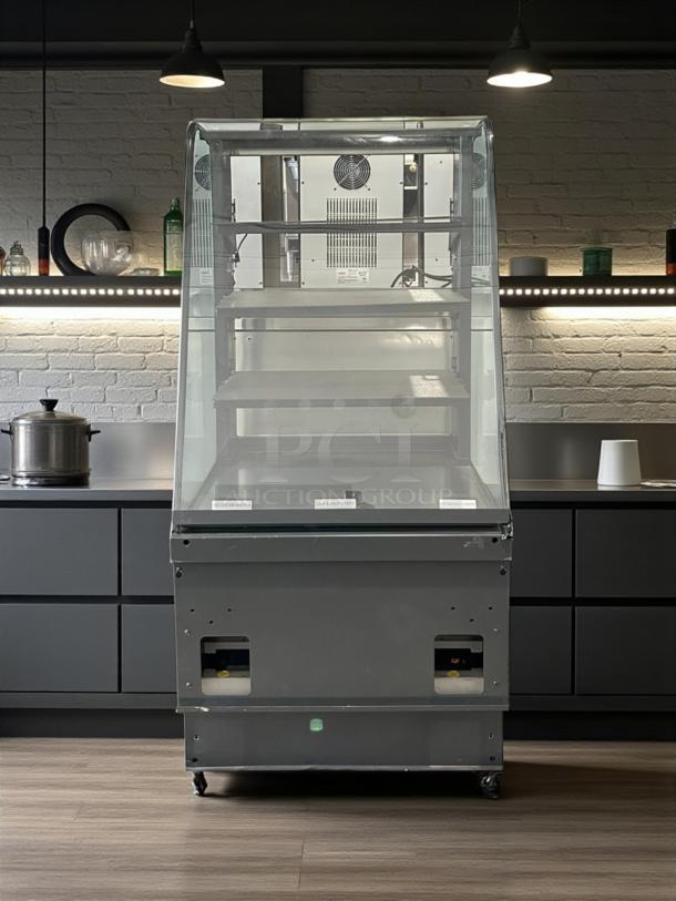 Curved glass refrigerated display case, excellent condition, 4 adjustable shelves, 115V, UL listed, fully tested, branded by Commercial Refrigeration Manufacturer.