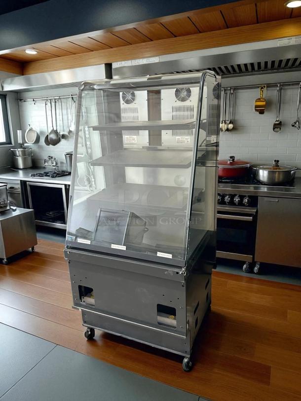Curved glass refrigerated display case, excellent condition, 4 adjustable shelves, UL listed, fully tested, operational.