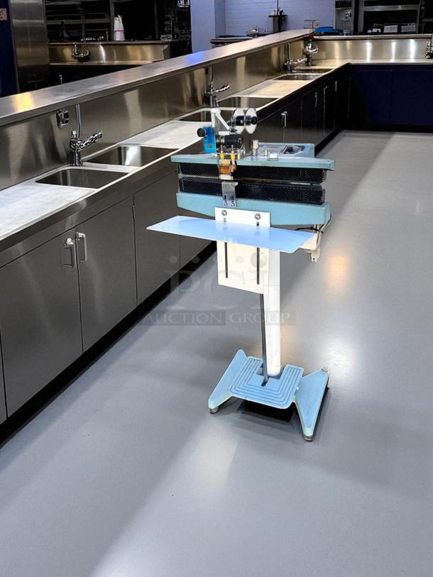 AIE ME-400CFN Constant Heat Sealer, 420W, 115V, premium condition, fully tested, operational, blue stand, industrial setting.