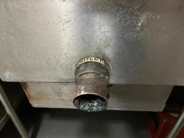 PDI Universal LJ-20 grease interceptor trap, 20 lb/10 GPM, showing outlet pipe with markings, in operational condition.
