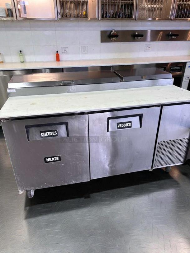 True TPP-67 commercial prep table; stainless steel; labels: "Cheeses," "Heats," "Veggies"; fully tested and working.