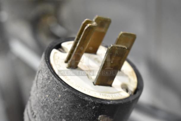 Close-up of an electrical plug for Blodgett Zephaire-100-E convection oven. Features a 3-prong design for 208V, 3-phase connection.