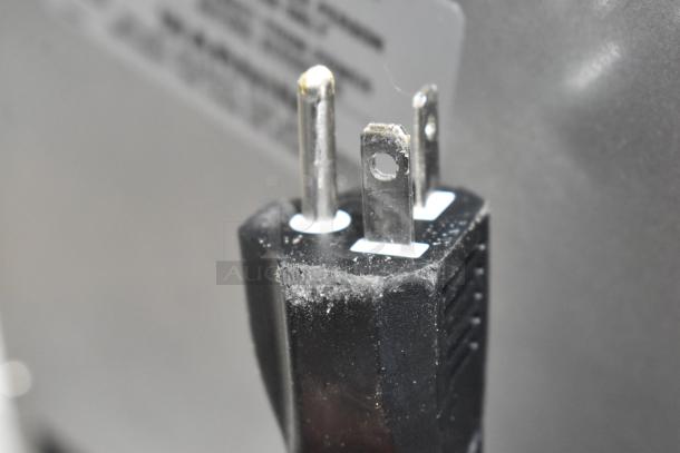 Close-up of a three-prong plug for the 2024 Moffat Turbofan E27M3 Convection Oven, showing minor wear.