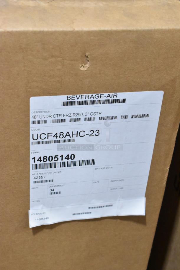 Box labeled "Beverage Air" with model UCF48AHC-23 details. Description: 48" undercounter freezer, serial 14805140, with visible dent.