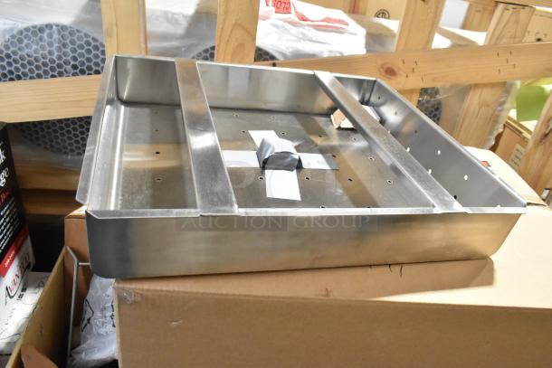 Brand new commercial drain bay strainer with minor scratches and dents, stainless steel, perforated design.