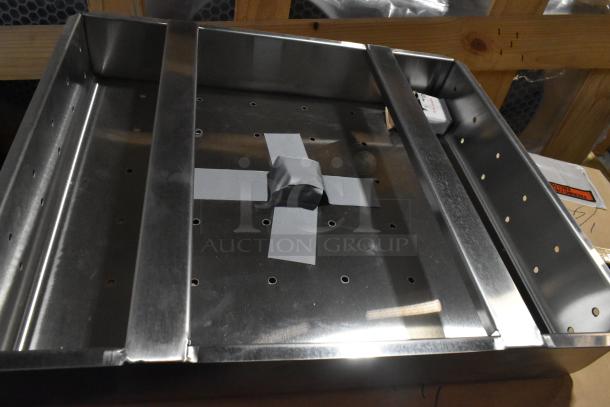 Brand new commercial drain bay strainer in stainless steel with minor scratches and dents. Perforated design for efficient drainage.