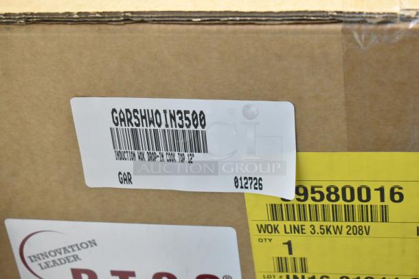 Brand new Garland SH/WO/IN 3500 induction wok, 208V, 1 phase. Scratch and dent condition. Box labeled with model and specs.