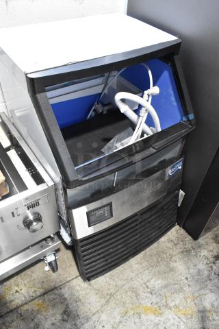 Brand new Avantco 194UCF280A 26" undercounter ice machine, 299 lb. capacity, 115V, minor scratches, uninstalled pipes visible.