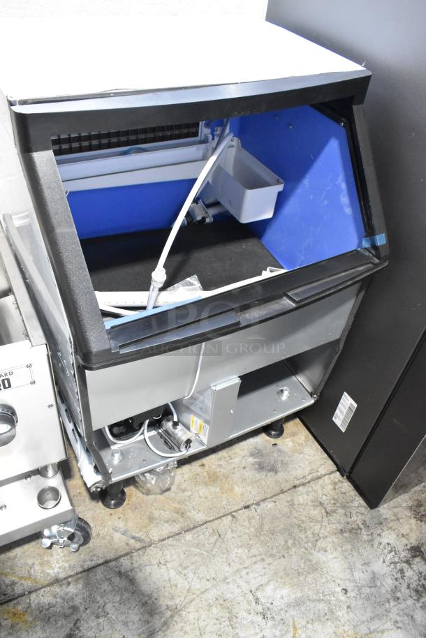 Brand new Avantco UC-F-280-A 26" commercial ice machine, 299 lb., 115V, 1 Phase, minor exterior scratches, open showing interior.