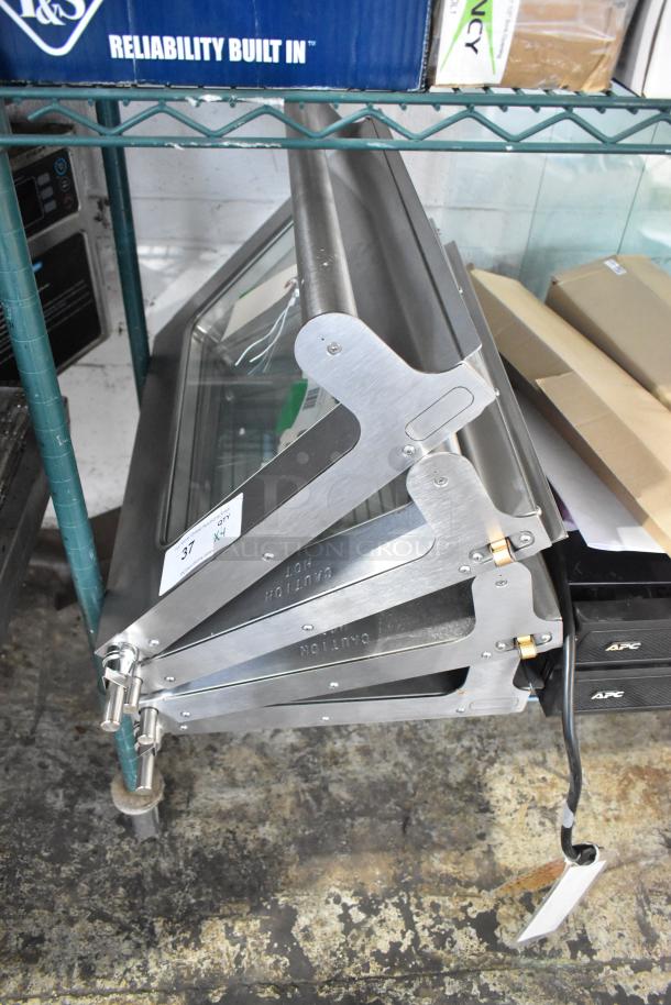 Four new microwave replacement doors, stainless steel, marked "Caution Hot," some scratch and dent.