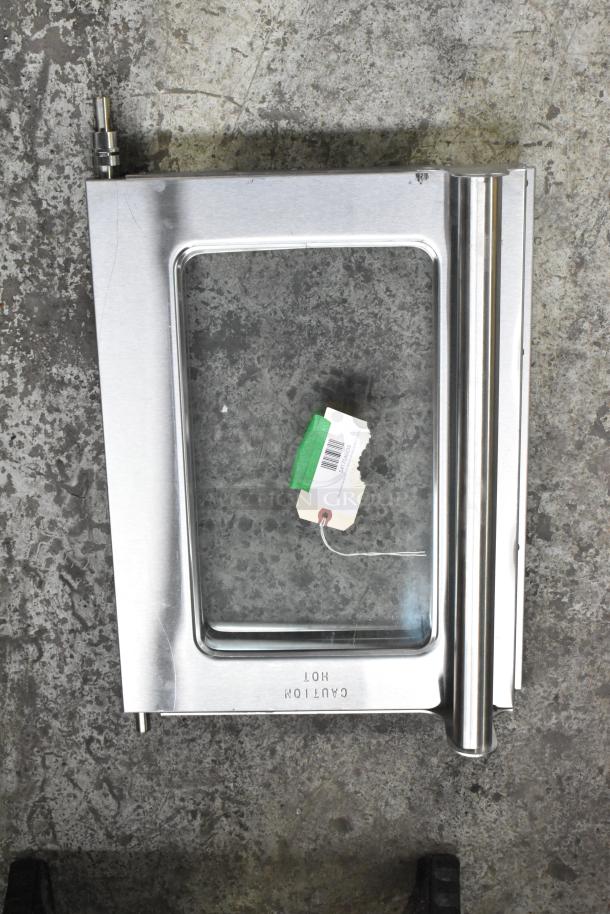 Brand new scratch and dent microwave replacement door. Stainless steel with glass panel, includes label. "Caution Hot" marked.