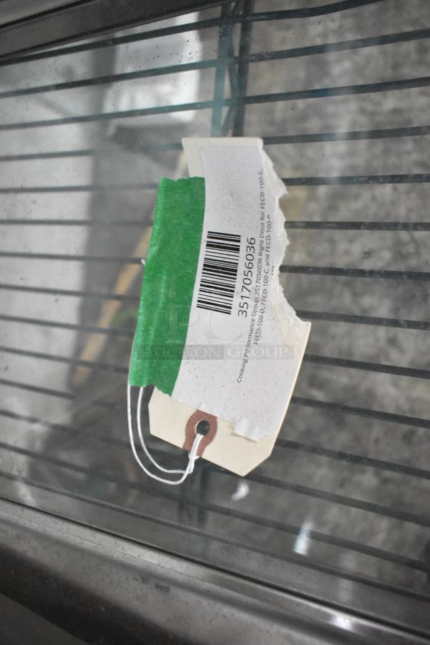 Microwave door with green tag displaying barcode and partial text "Cooking Performance Group 3905658". New, scratch and dent condition.