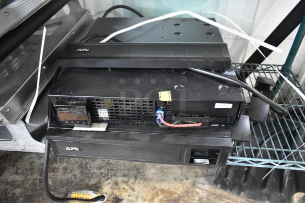 Brand new APC Uninterruptible Power Supply with minor scratches and dents, includes 2 boxes of metal pieces.