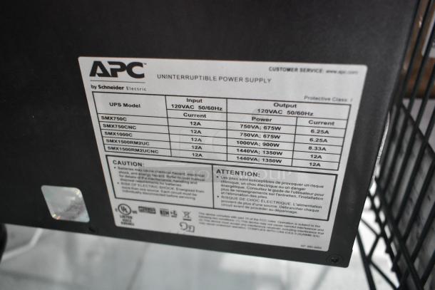Brand new APC uninterruptible power supply label detailing models, input/output specs, and cautionary information.