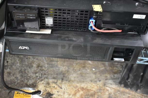 Brand new APC Uninterruptible Power Supply, scratch and dent, with two boxes of metal pieces. Features QR code label.