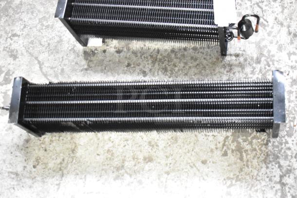 Three brand new evaporator coils with visible scratches and dents, designed for HVAC systems. Features finned coils, metal ends.