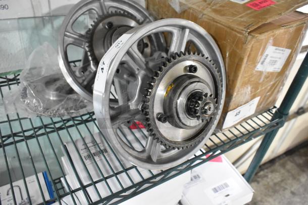 Brand new metal units on shelf; visible gear mechanism. Condition shows scratch and dent. Includes labels with numerical markings.