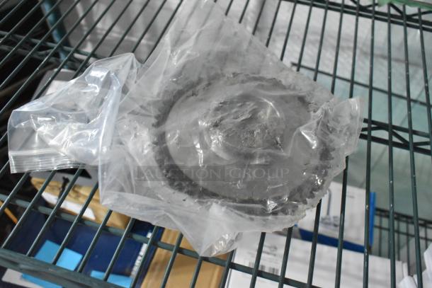 Brand new metal unit sealed in plastic. Slight scratches and dents visible. Positioned on metal shelving.