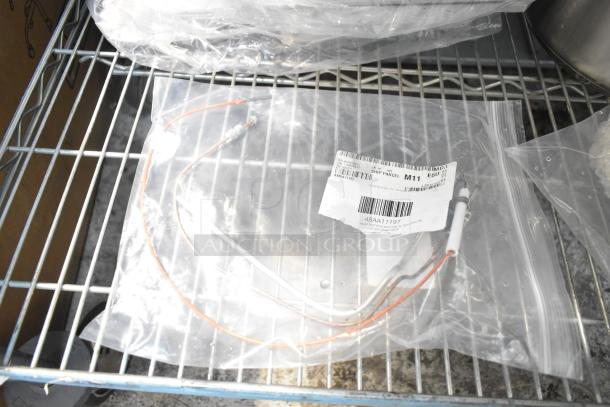 New scratch and dent items in sealed bags on shelf, including an auger and solenoid, labeled 48AA11197.