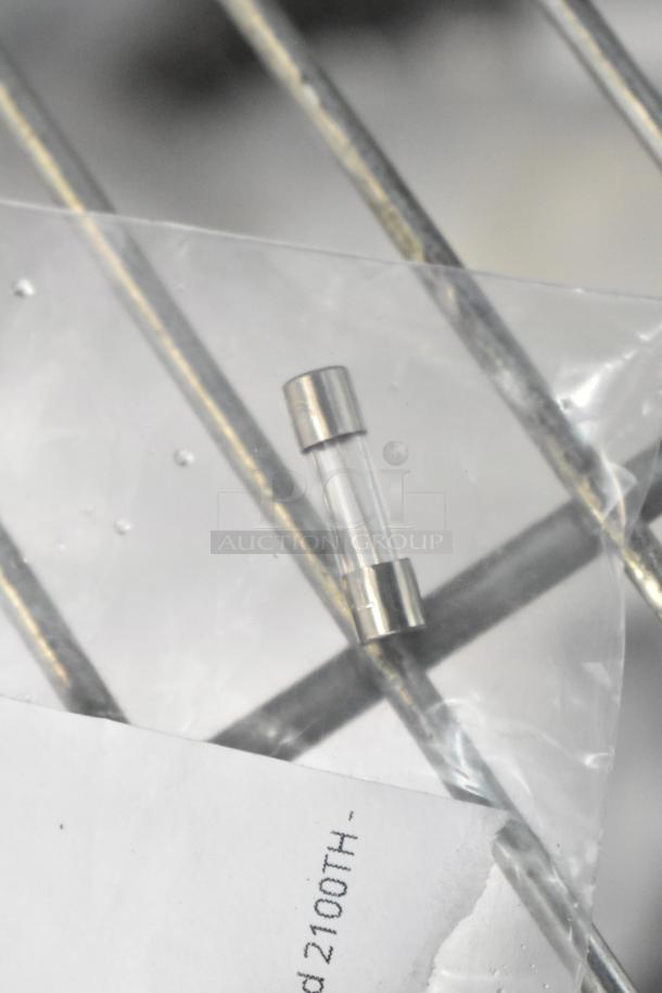 Brand new glass fuse, metal caps, part of a lot of scratch and dent items. Includes carbon filter, spring connection, bulb.