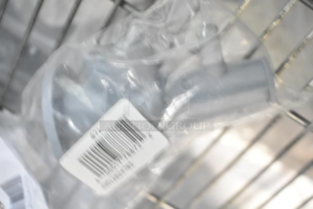 Three brand new appliance parts including a basket bushing and lower spray arm support, packaged with barcode visible.