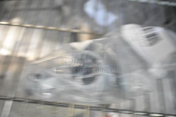 Three new scratch and dent items in plastic packaging, featuring basket bushing and lower spray arm support. Barcodes visible.