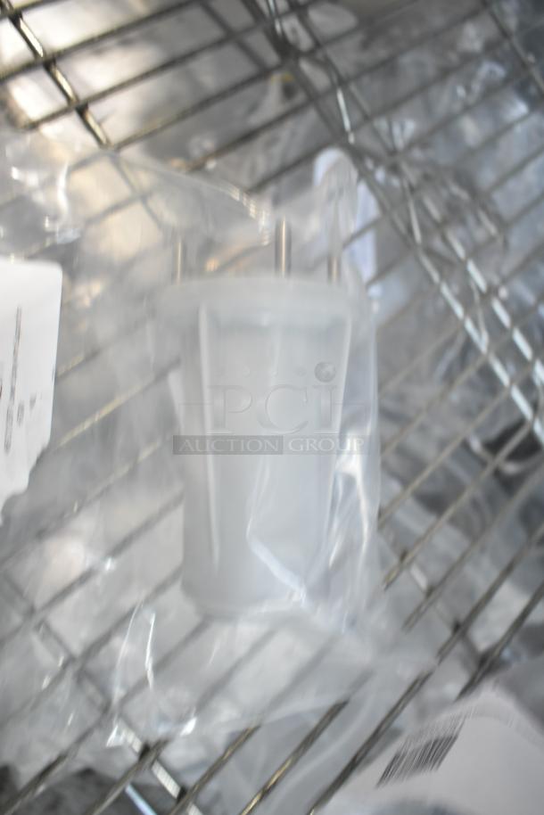 New dishwasher lower spray arm support in plastic bag, on metal rack, labeled for identification.