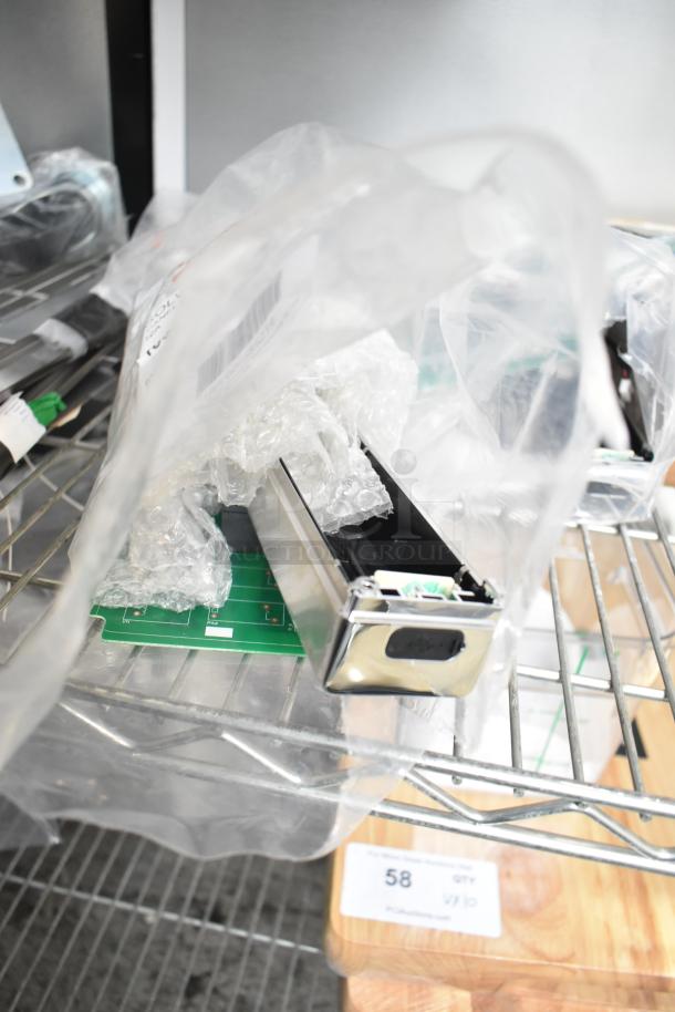 Four brand new control boards, partially wrapped in protective packaging, minor scratches visible, labeled "58" for auction.