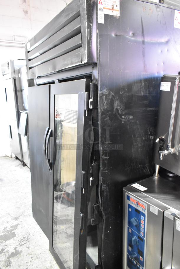 True STG2RPTVLD-2G-2S-HC commercial 2-door reach-in cooler. Notable exterior dents, operates at 115V, 1 phase.