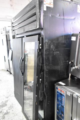 True STG2RPTVLD-2G-2S-HC commercial 2-door reach-in cooler. Notable exterior dents, operates at 115V, 1 phase.