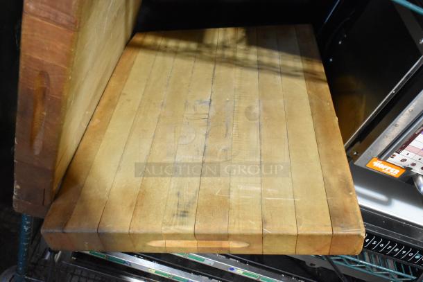 Two butcher block wooden cutting boards, showing light wear, feature sturdy construction and large surface area for food prep.